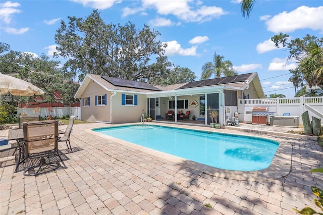view of swimming pool with a patio area, a fenced backyard, and outdoor dining space