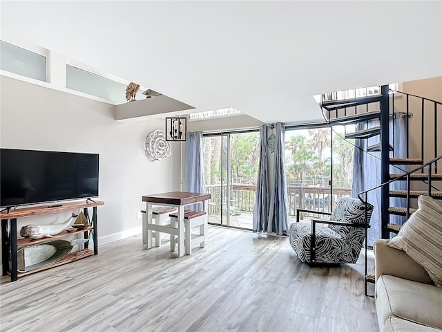 2695 N Seabreeze Pt Unit I1, Crystal River, FL 34429 - living room featuring baseboards, wood finished floors, and stairway