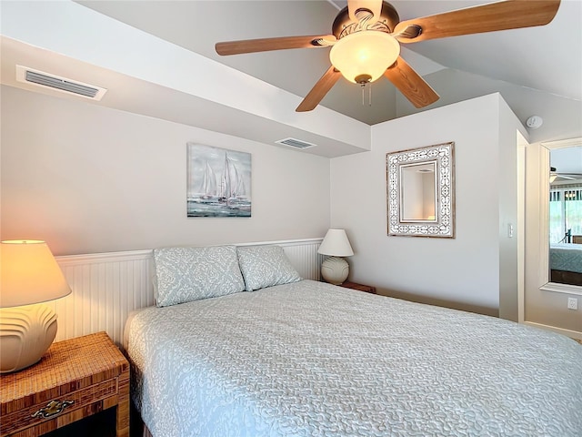 2695 N Seabreeze Pt Unit I1, Crystal River, FL 34429 - bedroom with a wainscoted wall, ceiling fan, and vaulted ceiling