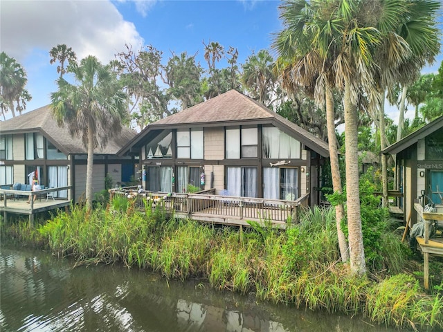 2695 N Seabreeze Pt Unit I1, Crystal River, FL 34429 - rear view of house with a deck with water view and a shingled roof
