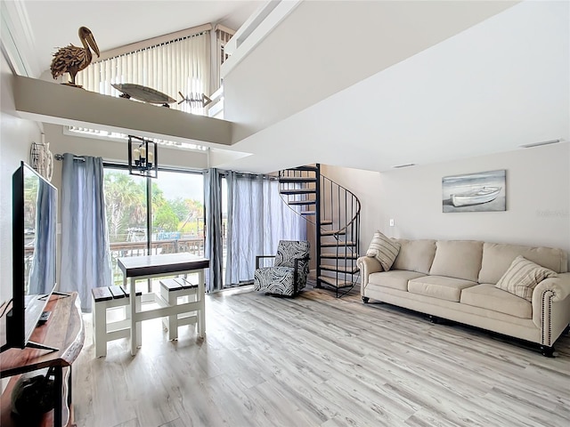 2695 N Seabreeze Pt Unit I1, Crystal River, FL 34429 - living room with stairway, wood finished floors, and a high ceiling