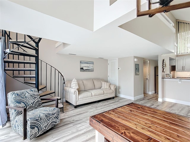 2695 N Seabreeze Pt Unit I1, Crystal River, FL 34429 - living area featuring light wood-style flooring, stairs, baseboards, and electric panel