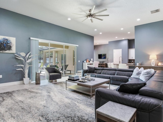 16220 Lake Armistead Way, Odessa, FL 33556 - living room with ceiling fan, recessed lighting, baseboards, concrete floors, and a textured ceiling