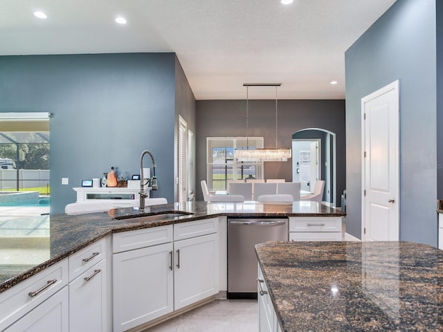 16220 Lake Armistead Way, Odessa, FL 33556 - kitchen featuring a sink, dishwasher, white cabinetry, dark stone counters, and hanging light fixtures