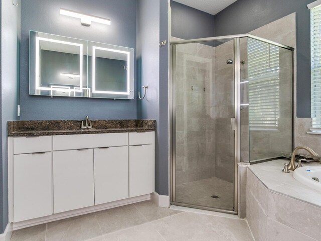 16220 Lake Armistead Way, Odessa, FL 33556 - bathroom featuring a stall shower, tile patterned flooring, a garden tub, and vanity