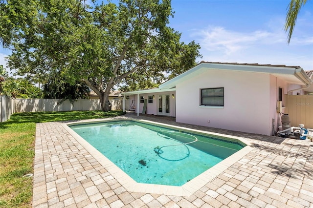view of pool with french doors and a patio area