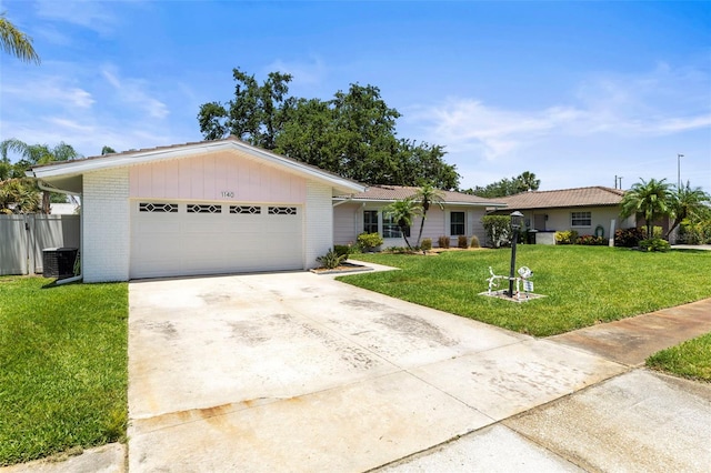ranch-style house with an attached garage, driveway, brick siding, and central AC unit