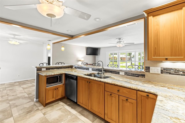 kitchen with appliances with stainless steel finishes, a sink, a ceiling fan, tasteful backsplash, and decorative light fixtures