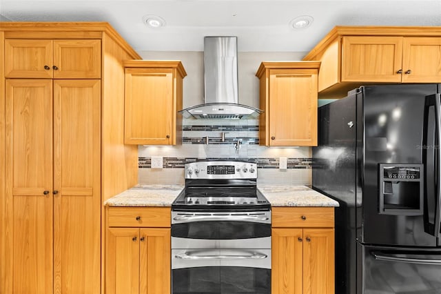 kitchen featuring black fridge, stainless steel electric range, wall chimney exhaust hood, tasteful backsplash, and light stone countertops