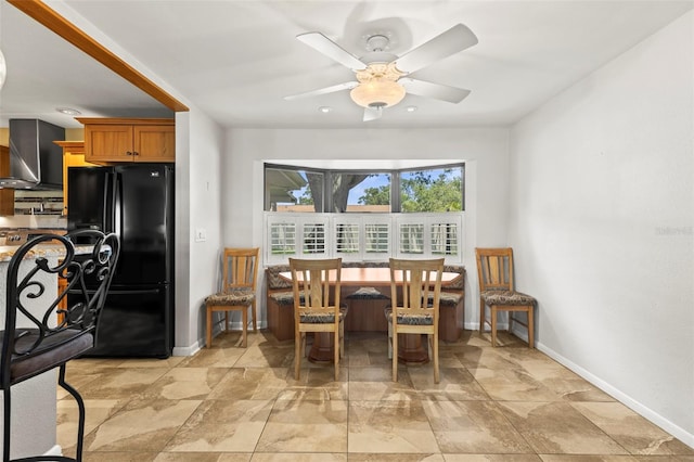 dining space featuring baseboards, a ceiling fan, light stone finish floors, and recessed lighting