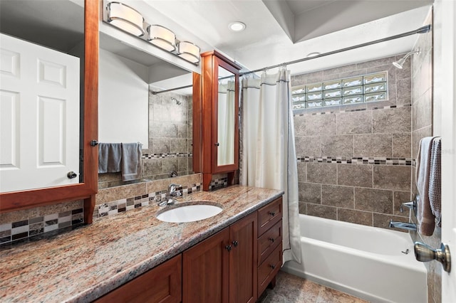 bathroom with tasteful backsplash, shower / tub combo with curtain, and vanity