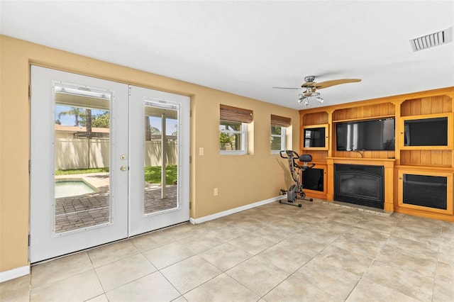 unfurnished living room with french doors, baseboards, a ceiling fan, and light tile patterned floors