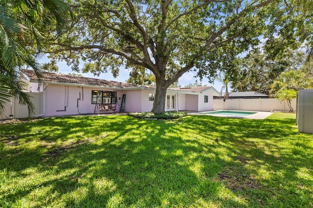 rear view of property featuring stucco siding