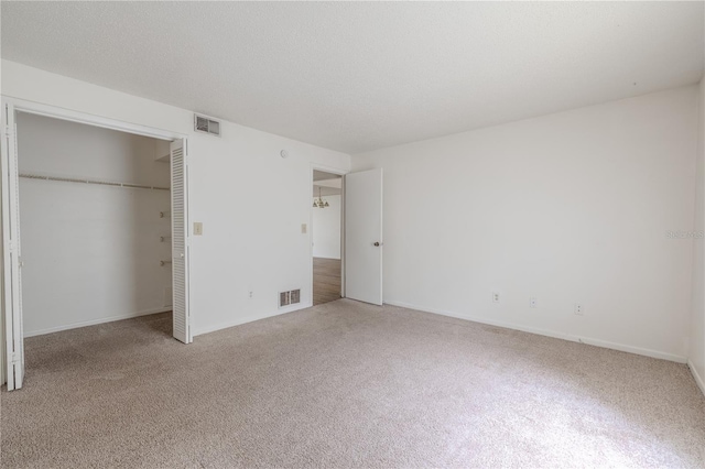 unfurnished bedroom with light colored carpet, a closet, and baseboards