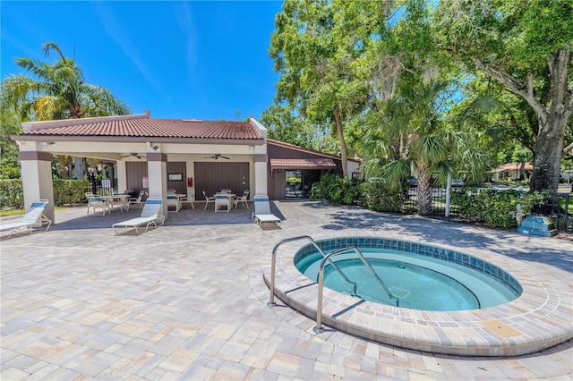 view of pool featuring ceiling fan, a hot tub, a patio, and fence