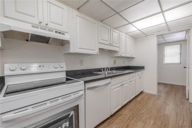 kitchen featuring white appliances, under cabinet range hood, white cabinetry, light wood-style floors, and dark countertops