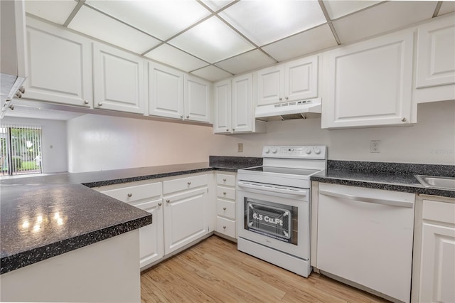 kitchen with white appliances, under cabinet range hood, white cabinets, light wood-style floors, and dark countertops
