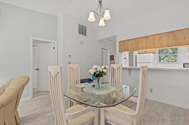 39650 US Highway 19 N Unit 553, Tarpon Springs, FL 34689 - dining room with a chandelier, light wood-style flooring, and baseboards