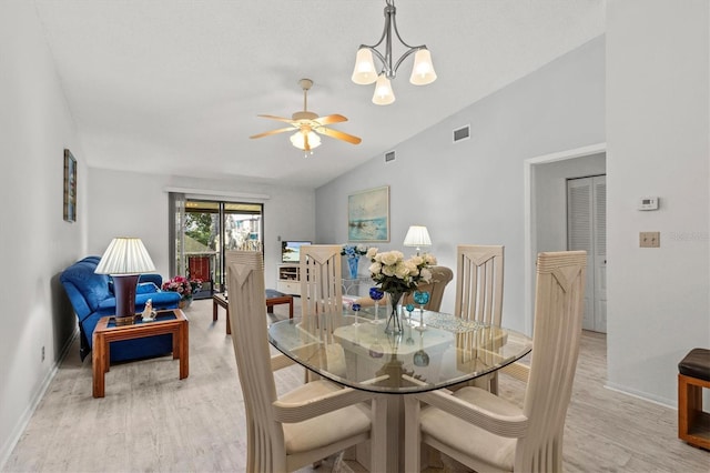 39650 US Highway 19 N Unit 553, Tarpon Springs, FL 34689 - dining room with vaulted ceiling, baseboards, light wood-style floors, a chandelier, and a ceiling fan
