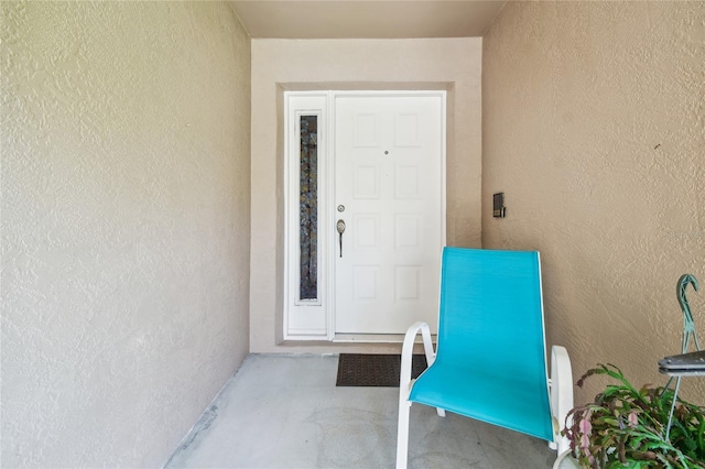 property entrance with stucco siding