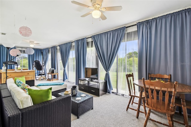 carpeted living room featuring ceiling fan