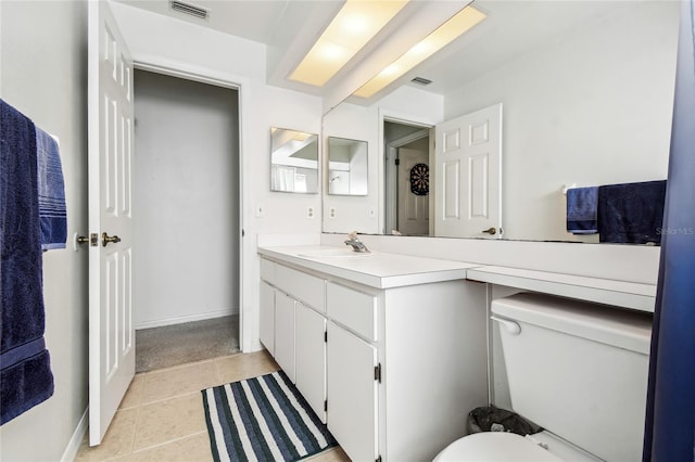 bathroom featuring vanity, tile patterned flooring, and toilet