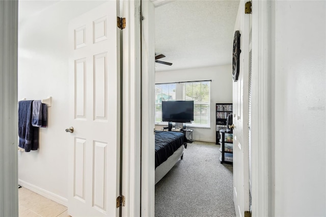 bedroom featuring baseboards and a textured ceiling