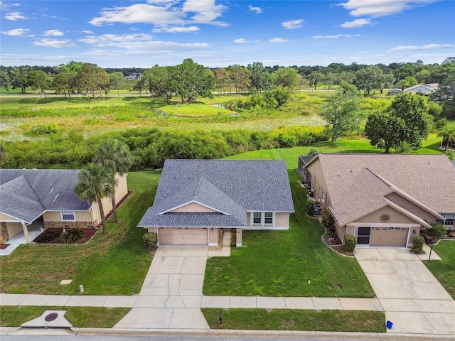 aerial view of property and surrounding area featuring a tree filled landscape