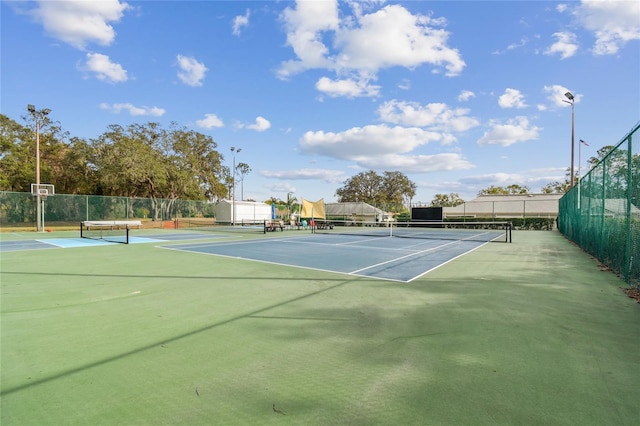 view of tennis court with fence