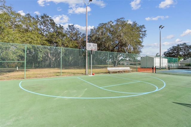 view of basketball court featuring community basketball court and fence