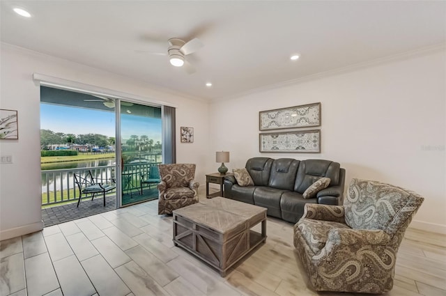 living area featuring ornamental molding, ceiling fan, a water view, recessed lighting, and baseboards