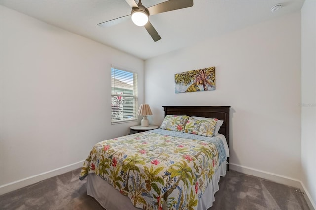 carpeted bedroom featuring baseboards and a ceiling fan