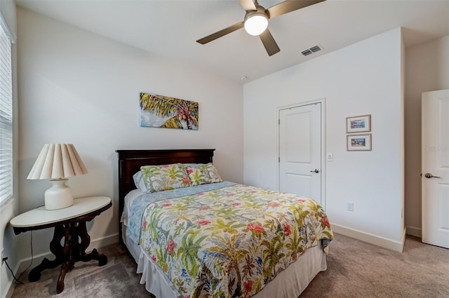 carpeted bedroom with baseboards and a ceiling fan