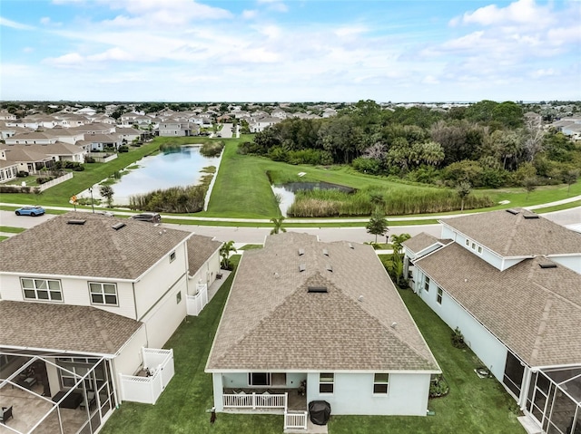 aerial view of residential area featuring a nearby body of water
