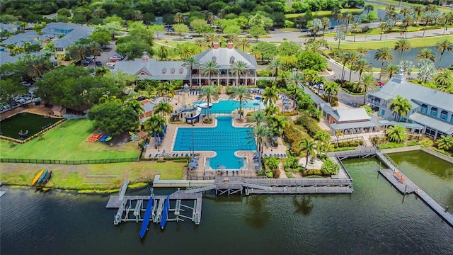 drone / aerial view of a pool and a large body of water