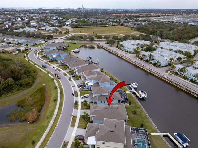 aerial overview of property's location with a large body of water and nearby suburban area