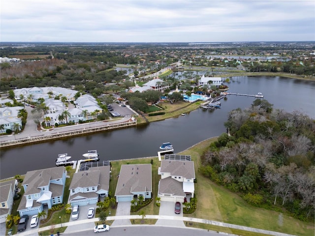 aerial view of property and surrounding area featuring nearby suburban area and a nearby body of water