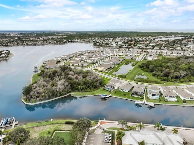aerial view of property's location with a large body of water and nearby suburban area