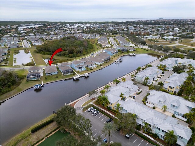 view of property location featuring a nearby body of water and nearby suburban area