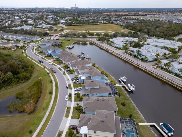 aerial view of property and surrounding area with a nearby body of water and nearby suburban area