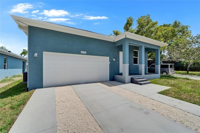 6097 Vermont Ave, New Port Richey, FL 34653 - contemporary house with driveway, stucco siding, and an attached garage