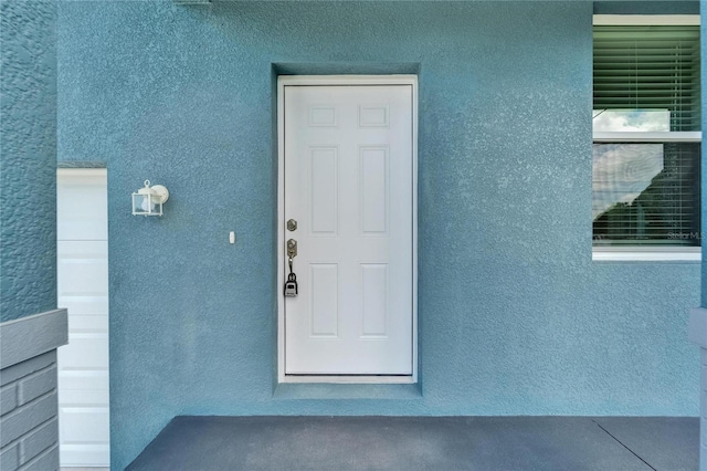 6097 Vermont Ave, New Port Richey, FL 34653 - doorway to property with stucco siding