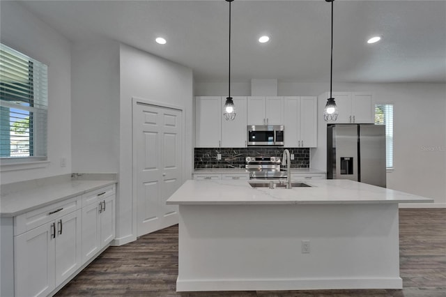 6097 Vermont Ave, New Port Richey, FL 34653 - kitchen with appliances with stainless steel finishes, a sink, dark wood-style floors, tasteful backsplash, and recessed lighting