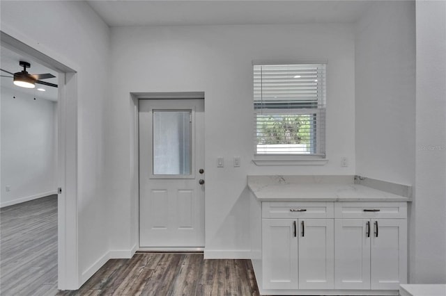 6097 Vermont Ave, New Port Richey, FL 34653 - entryway with dark wood finished floors, baseboards, and ceiling fan