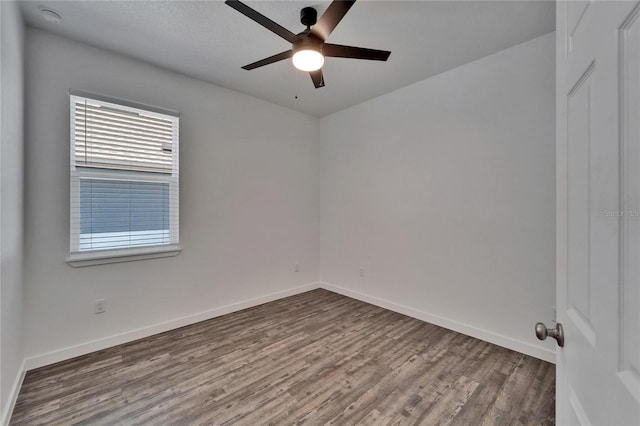 6097 Vermont Ave, New Port Richey, FL 34653 - unfurnished room with wood finished floors, a ceiling fan, and baseboards