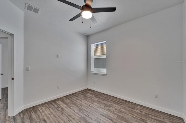 6097 Vermont Ave, New Port Richey, FL 34653 - empty room featuring wood finished floors, a ceiling fan, and baseboards