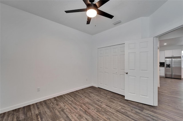 6097 Vermont Ave, New Port Richey, FL 34653 - unfurnished bedroom with stainless steel fridge with ice dispenser, wood finished floors, baseboards, a closet, and ceiling fan