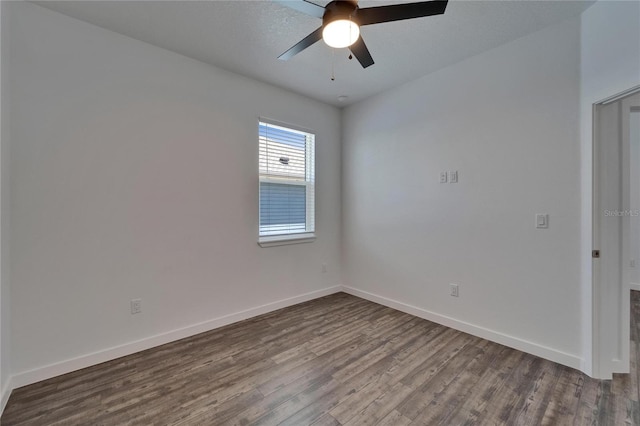 6097 Vermont Ave, New Port Richey, FL 34653 - unfurnished room featuring dark wood-type flooring, a ceiling fan, and baseboards