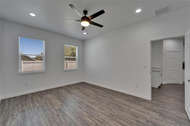 6097 Vermont Ave, New Port Richey, FL 34653 - unfurnished room with dark wood-type flooring, a ceiling fan, baseboards, and recessed lighting