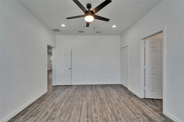 6097 Vermont Ave, New Port Richey, FL 34653 - unfurnished bedroom featuring wood finished floors, baseboards, recessed lighting, and a ceiling fan